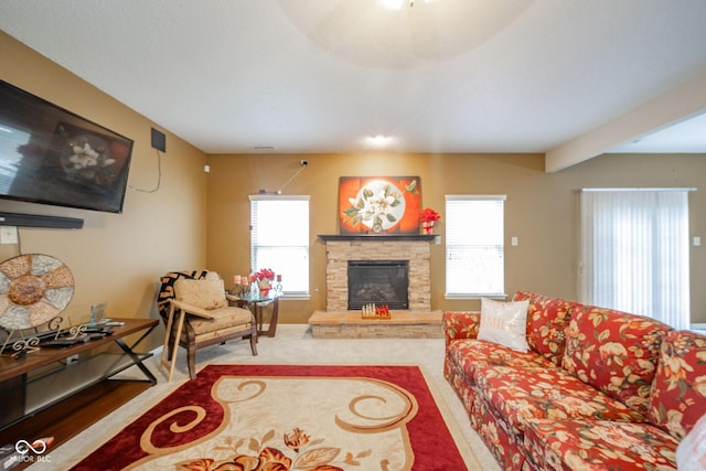 living area with a stone fireplace