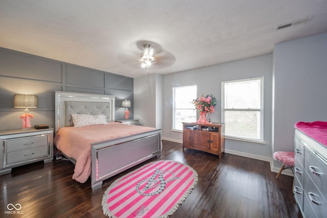 bedroom featuring visible vents, baseboards, and dark wood-style floors