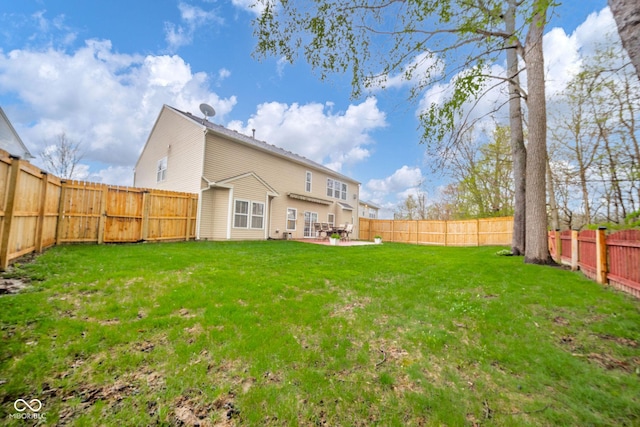 back of house with a fenced backyard, a patio area, and a yard