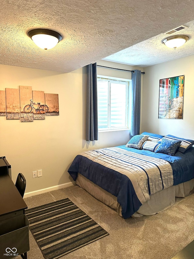 bedroom featuring carpet flooring, a textured ceiling, and baseboards