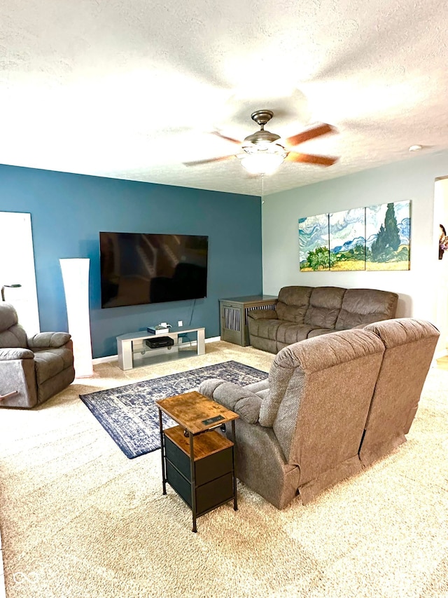 living area with carpet floors, a ceiling fan, and a textured ceiling