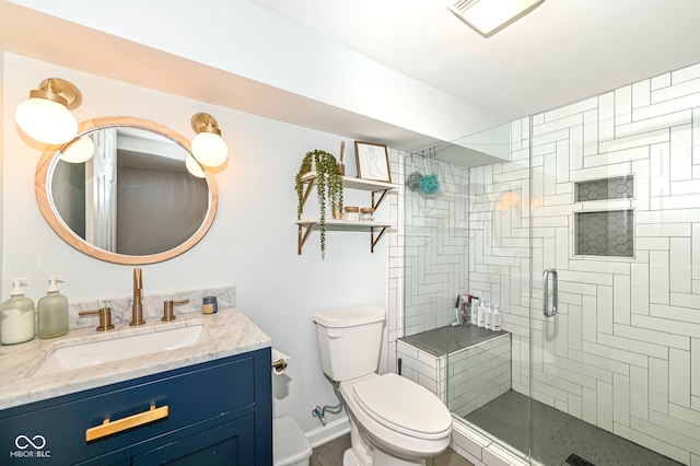 full bathroom with toilet, baseboards, a shower stall, and vanity