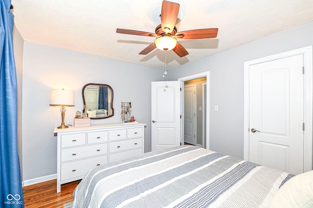bedroom featuring baseboards, ceiling fan, and wood finished floors