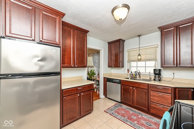 kitchen with a sink, stainless steel appliances, and dark brown cabinets