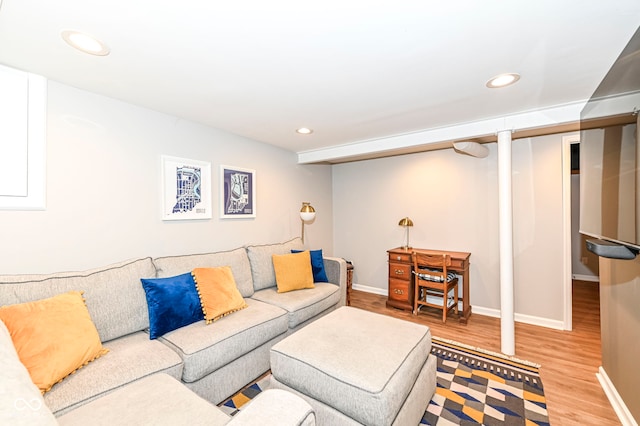living area with recessed lighting, baseboards, and wood finished floors