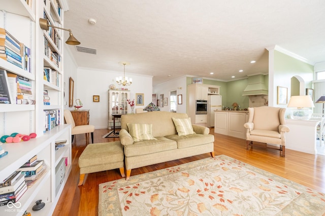 476 Glenview Dr, Greencastle, IN 46135 - living room featuring ornamental molding, light wood finished floors, and a chandelier