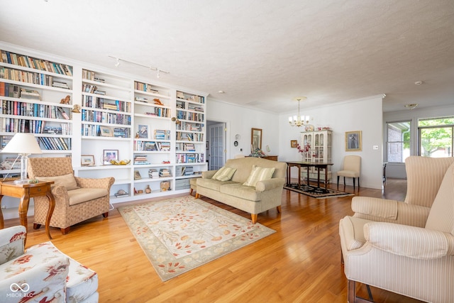 476 Glenview Dr, Greencastle, IN 46135 - living room with wood finished floors, a chandelier, crown molding, and a textured ceiling