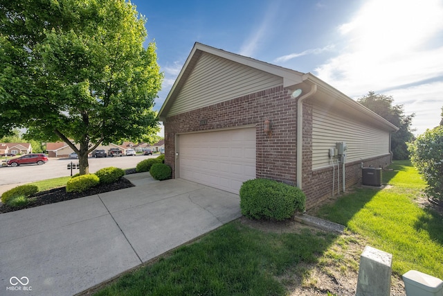 476 Glenview Dr, Greencastle, IN 46135 - view of side of home featuring brick siding, concrete driveway, and a lawn