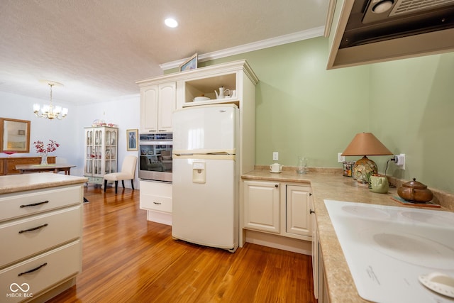 476 Glenview Dr, Greencastle, IN 46135 - kitchen with freestanding refrigerator, oven, light countertops, crown molding, and light wood-style floors