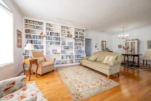 476 Glenview Dr, Greencastle, IN 46135 - living room with wood finished floors, a chandelier, and crown molding