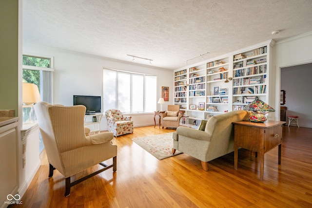 476 Glenview Dr, Greencastle, IN 46135 - living area featuring healthy amount of natural light, wood finished floors, a textured ceiling, and rail lighting