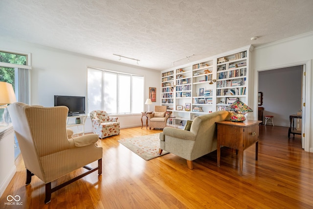 476 Glenview Dr, Greencastle, IN 46135 - living area with wood finished floors, track lighting, built in shelves, and a textured ceiling