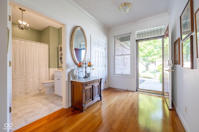 476 Glenview Dr, Greencastle, IN 46135 - entryway with crown molding, light wood-style floors, and a chandelier