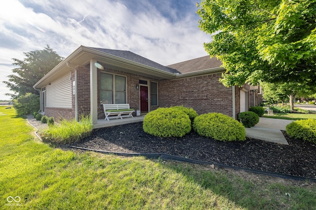 476 Glenview Dr, Greencastle, IN 46135 - ranch-style house featuring covered porch, brick siding, a front yard, and an attached garage