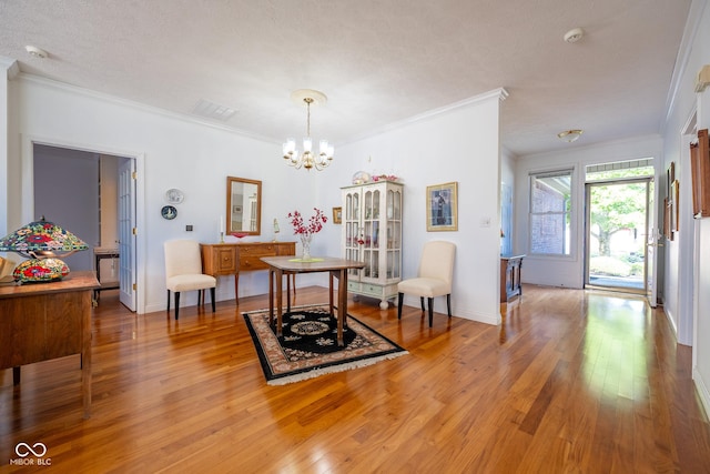 476 Glenview Dr, Greencastle, IN 46135 - dining space with crown molding, a chandelier, and light wood-style floors