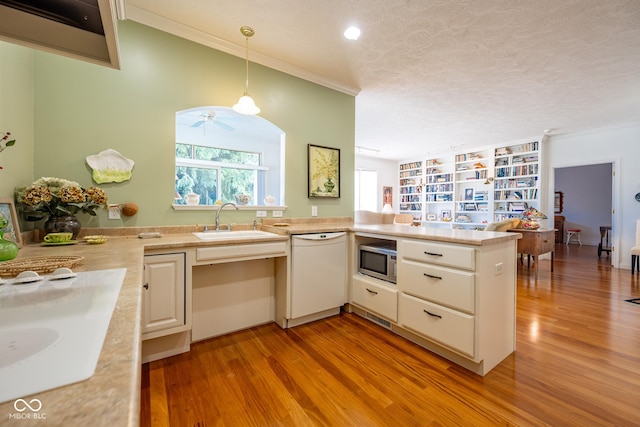 476 Glenview Dr, Greencastle, IN 46135 - kitchen with dishwasher, stainless steel microwave, light wood finished floors, light countertops, and crown molding