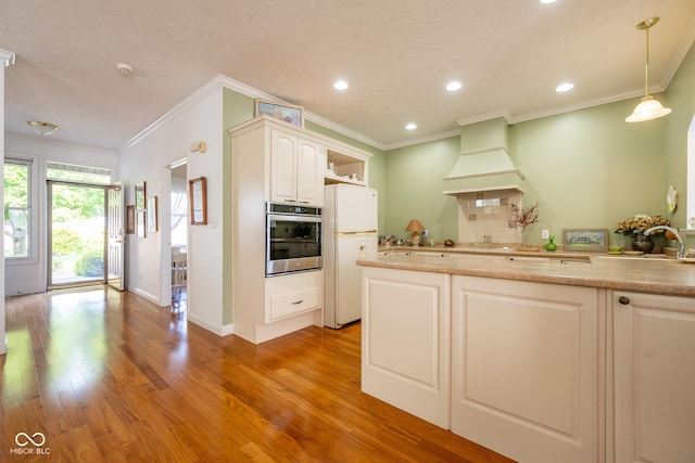 476 Glenview Dr, Greencastle, IN 46135 - kitchen with freestanding refrigerator, oven, premium range hood, ornamental molding, and light wood finished floors