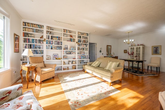 476 Glenview Dr, Greencastle, IN 46135 - living room with healthy amount of natural light, wood finished floors, a chandelier, and ornamental molding