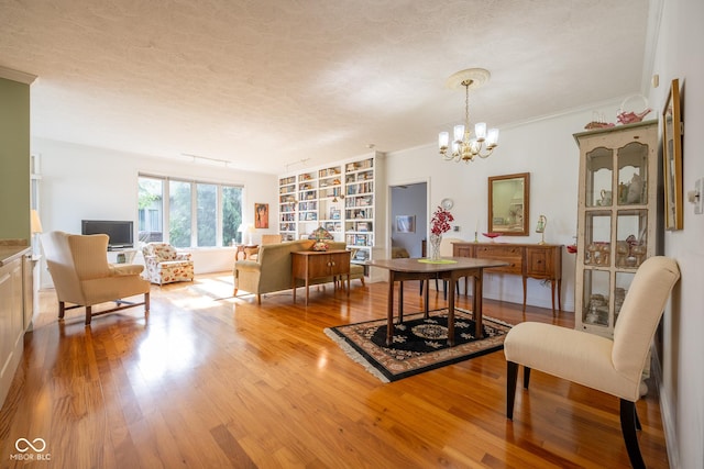 476 Glenview Dr, Greencastle, IN 46135 - dining room with a textured ceiling, wood finished floors, a chandelier, built in features, and ornamental molding