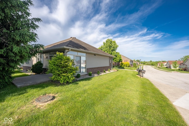 476 Glenview Dr, Greencastle, IN 46135 - view of home's exterior featuring brick siding, a yard, and a residential view