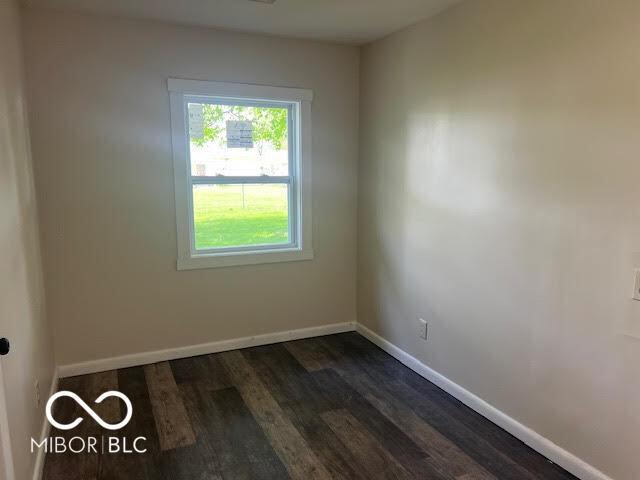 1204 Ladoga Rd, Crawfordsville, IN 47933 - spare room with baseboards and dark wood-type flooring