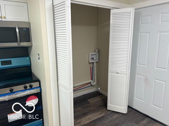 1204 Ladoga Rd, Crawfordsville, IN 47933 - interior details with baseboards, white cabinetry, stainless steel appliances, and dark wood-type flooring