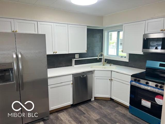 1204 Ladoga Rd, Crawfordsville, IN 47933 - kitchen featuring appliances with stainless steel finishes, white cabinetry, and a sink