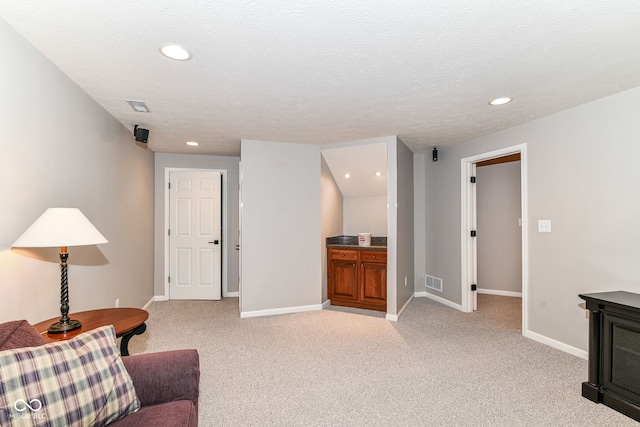 living room with recessed lighting, baseboards, visible vents, and light colored carpet
