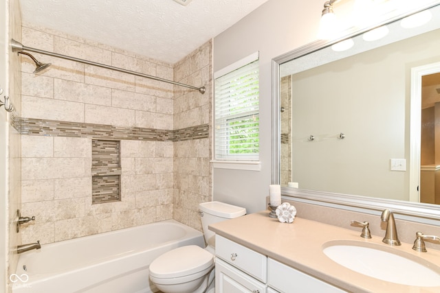 bathroom featuring vanity, shower / bathing tub combination, toilet, and a textured ceiling
