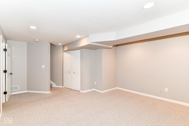 finished basement with light colored carpet, recessed lighting, and baseboards
