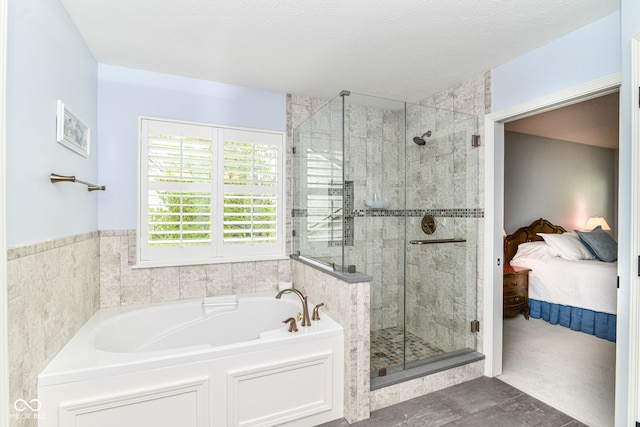full bathroom with ensuite bathroom, a stall shower, and a bath