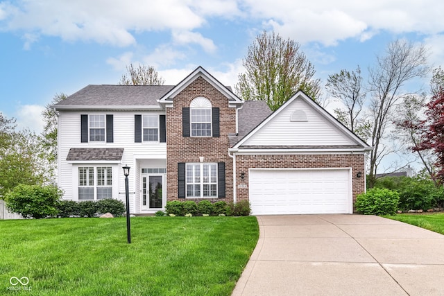 colonial-style house featuring a front yard, brick siding, a shingled roof, concrete driveway, and an attached garage