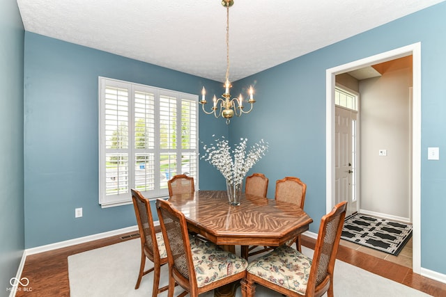 dining area featuring baseboards, a chandelier, and a wealth of natural light