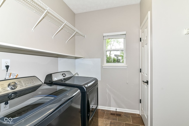 clothes washing area with washer and dryer, laundry area, visible vents, and baseboards