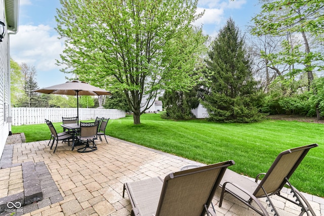 view of patio featuring fence and outdoor dining space