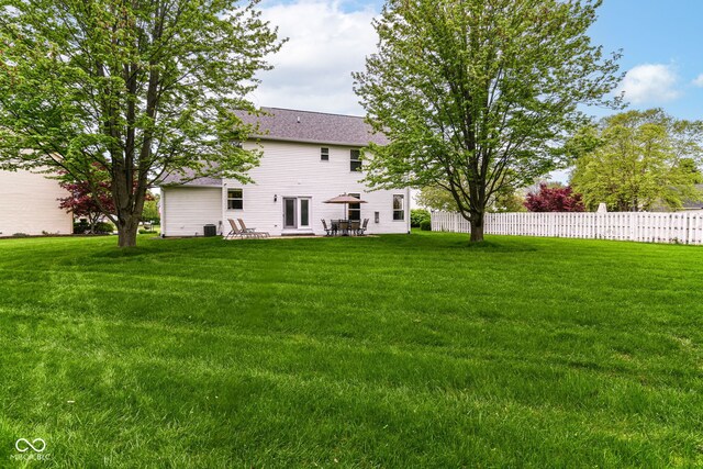 view of yard featuring a patio, fence, and cooling unit