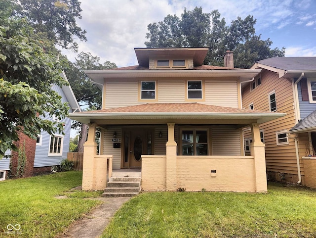 3629 Birchwood Ave, Indianapolis, IN 46205 - american foursquare style home with roof with shingles, a chimney, a porch, and a front lawn