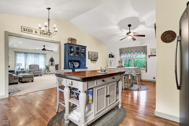 1630 N 400 W, Bargersville, IN 46106 - kitchen with freestanding refrigerator, butcher block counters, lofted ceiling, a healthy amount of sunlight, and ceiling fan with notable chandelier