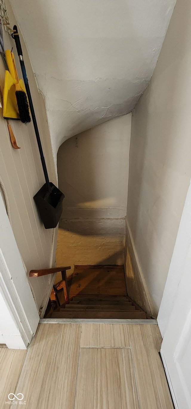 stairs featuring wood finished floors