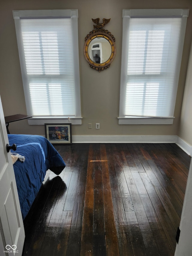 bedroom with baseboards and hardwood / wood-style floors