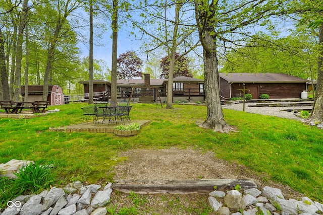 view of yard featuring an outbuilding and a patio area