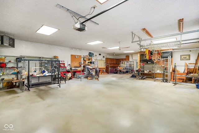 garage with a workshop area and a garage door opener