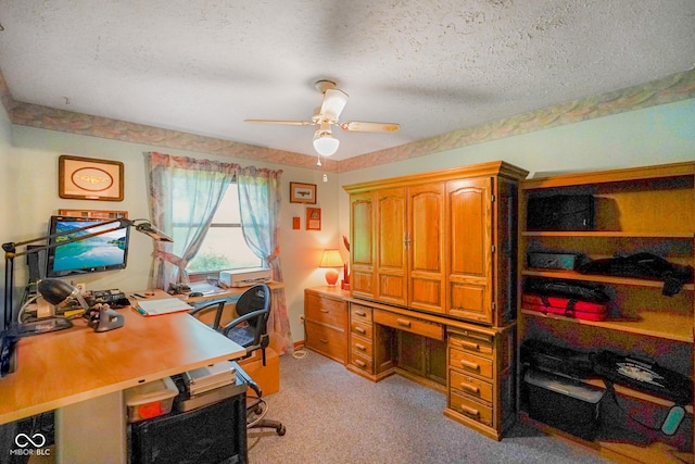 home office featuring a textured ceiling, light colored carpet, and ceiling fan