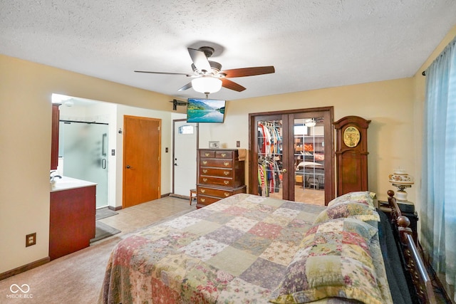bedroom featuring carpet flooring, a textured ceiling, french doors, a ceiling fan, and baseboards