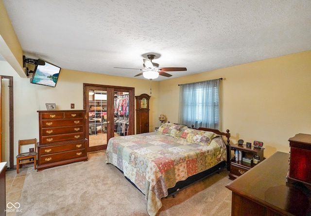 bedroom with access to outside, a textured ceiling, ceiling fan, and multiple windows