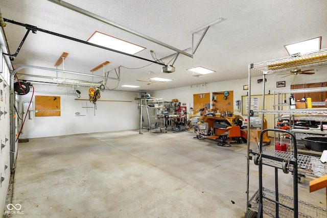 garage with a workshop area and a garage door opener