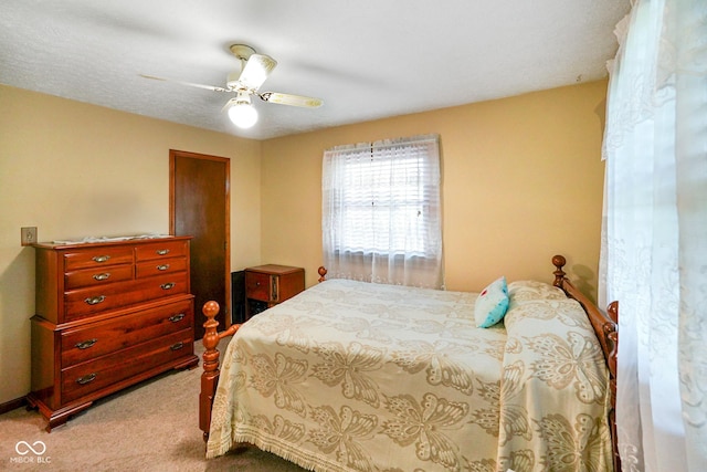 carpeted bedroom featuring a ceiling fan