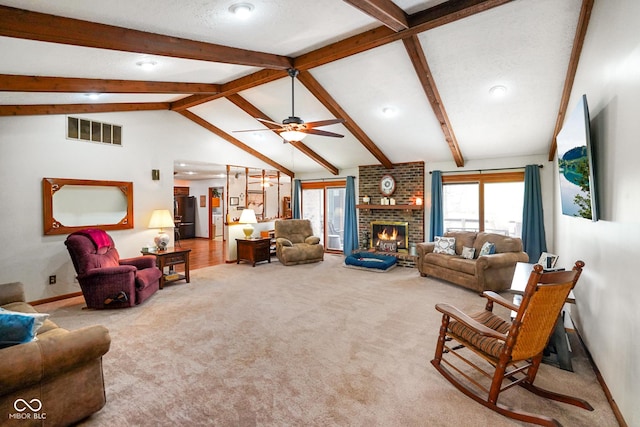 living room with carpet flooring, visible vents, lofted ceiling with beams, and a wealth of natural light