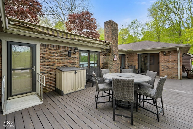 wooden terrace featuring outdoor dining area