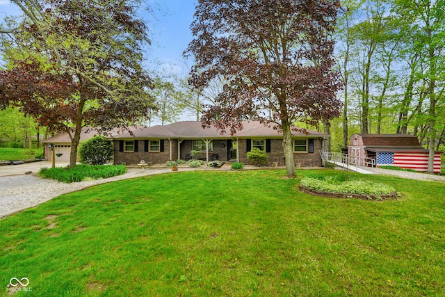 ranch-style home featuring brick siding, a front lawn, and concrete driveway